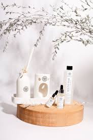 Youghazi White Oud home fragrance products arranged on a wooden stand